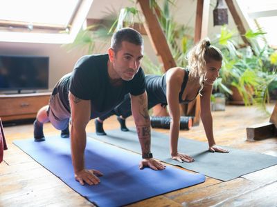 Man holding a stable plank position on a mat.