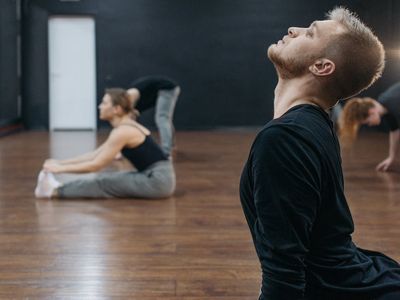 Side view of a person performing a balance exercise.